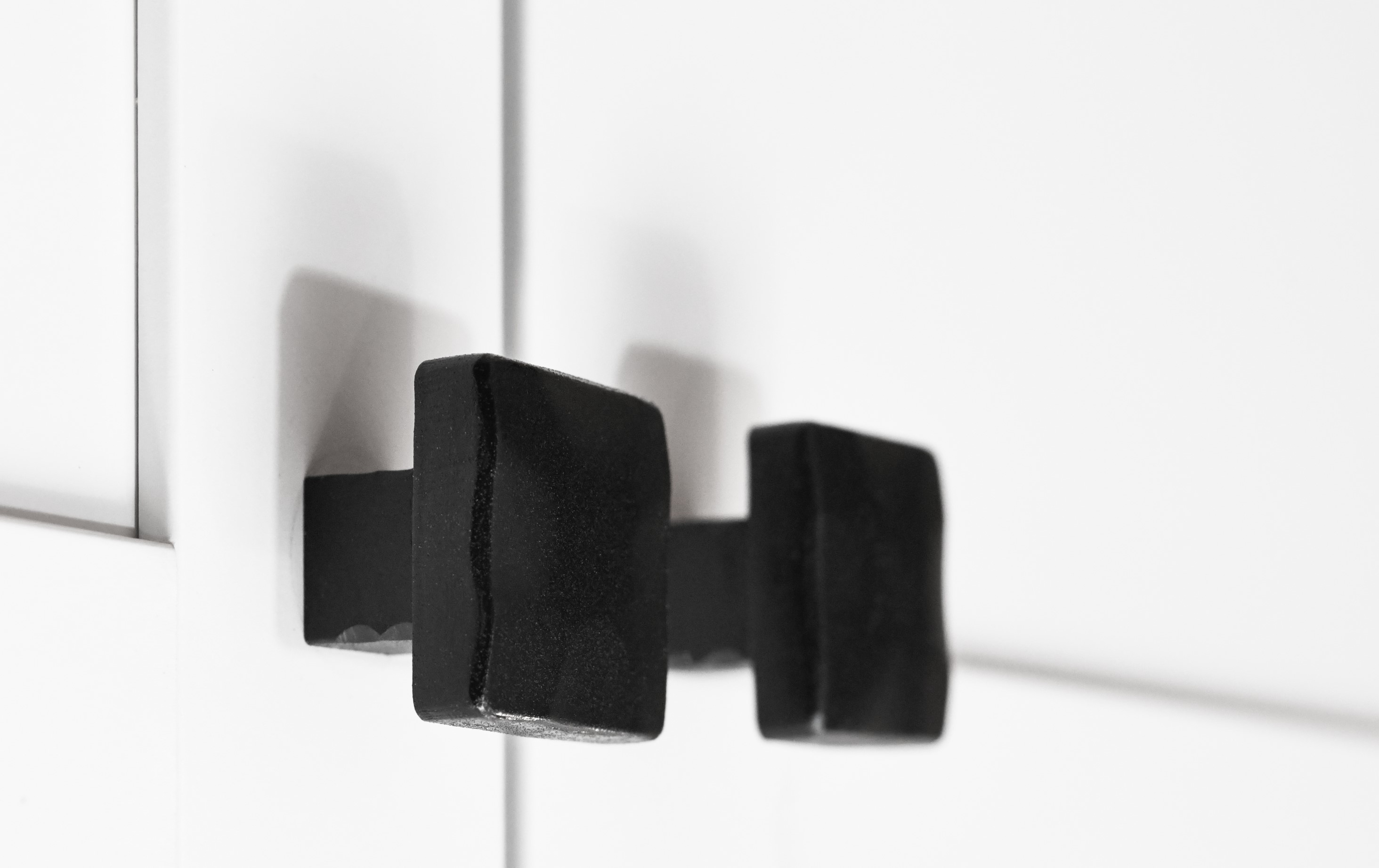 Stonecut knobs installed on white cabinet